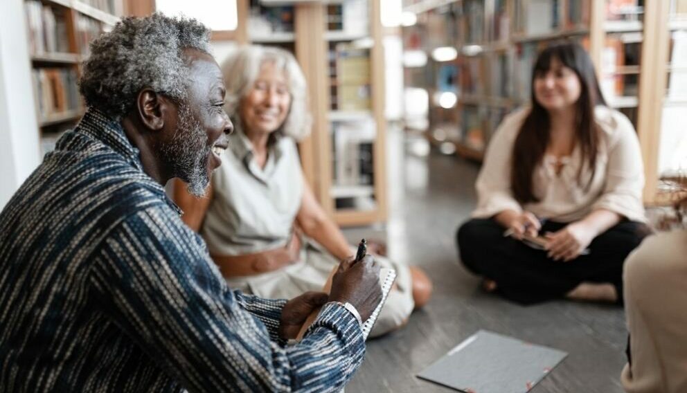 An older man laughing in a group