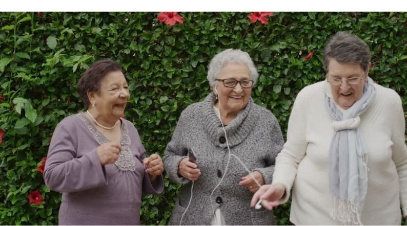 Three older women laughing together