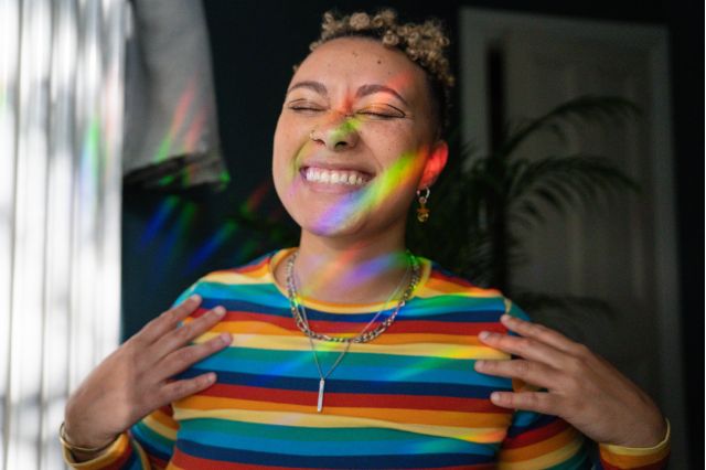 rainbow dressed person smiling